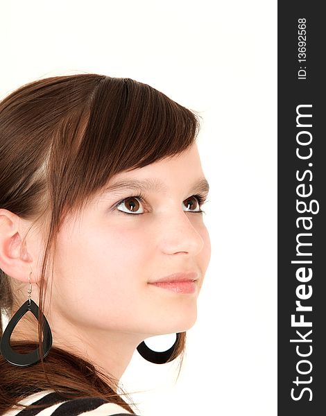 Portrait of young teenage girl looking up, studio shot