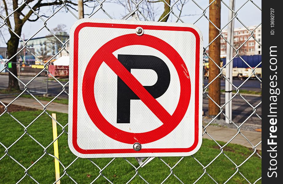 No parking sign mounted on chain link fence