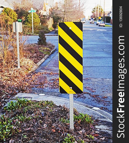 Caution sign placed within street berm. Caution sign placed within street berm