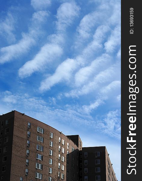 Wavy Clouds Over Brick Building