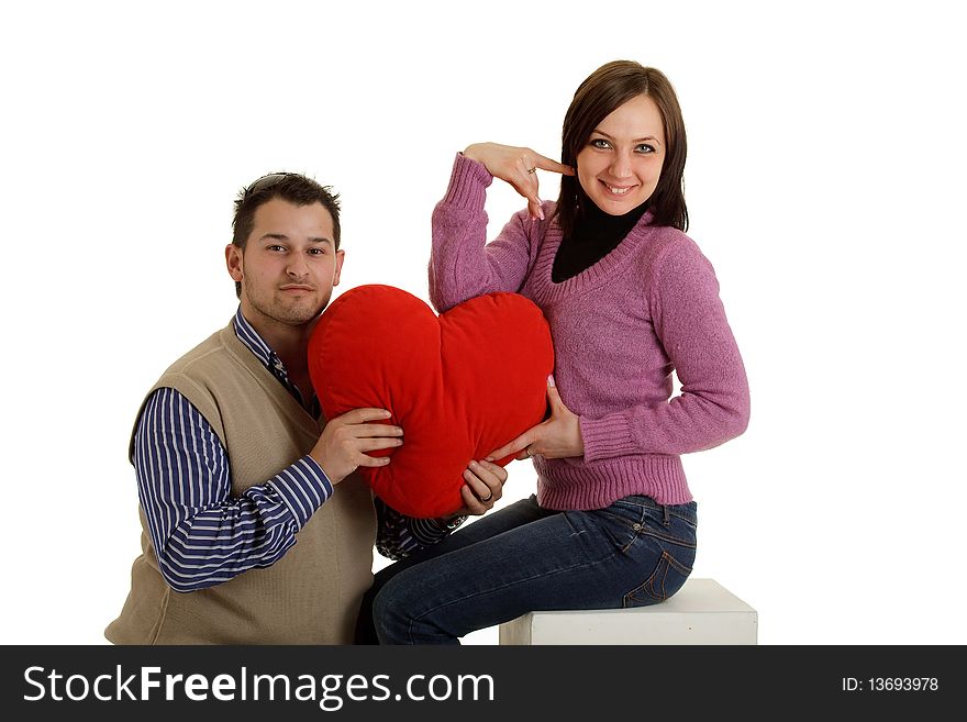 Photo of coupple holding a heart pillow. Photo of coupple holding a heart pillow