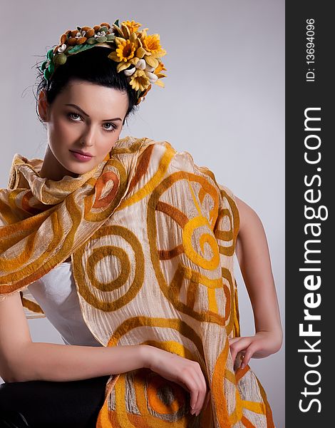 Young attractive woman dressed in fashionable handmade clothing on isolated background. Young attractive woman dressed in fashionable handmade clothing on isolated background