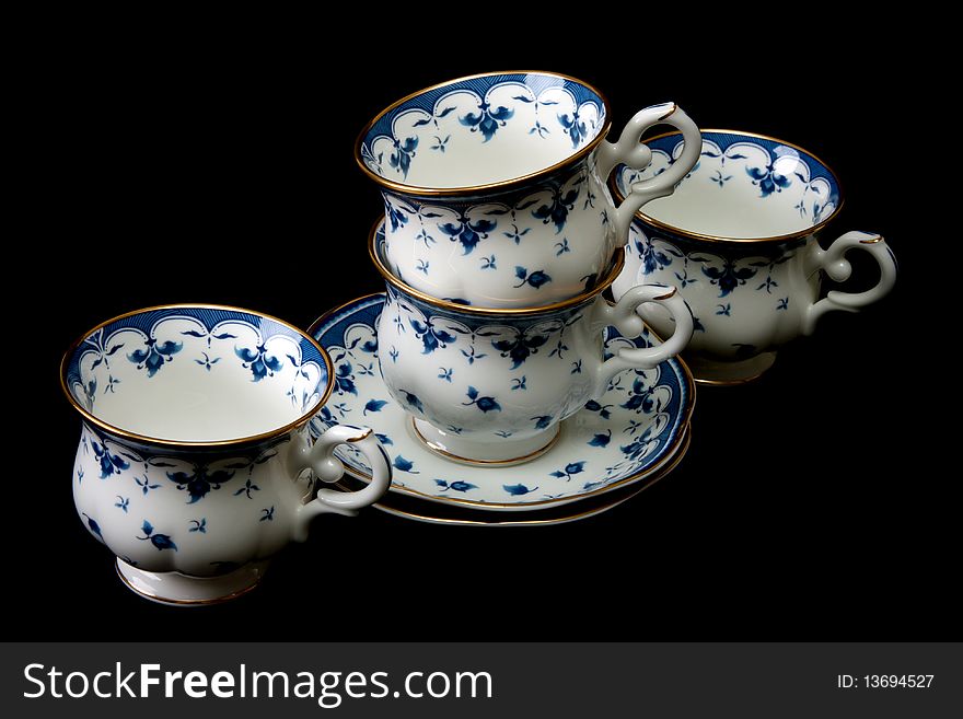 Four tea cups on saucer insulated on white background