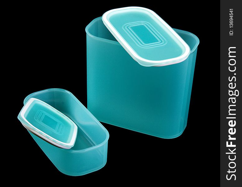 Two blue translucent plastic containers insulated on black background