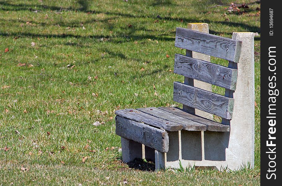 A wood park bench in Centennial Park in Fowlerville Michigan. A wood park bench in Centennial Park in Fowlerville Michigan.