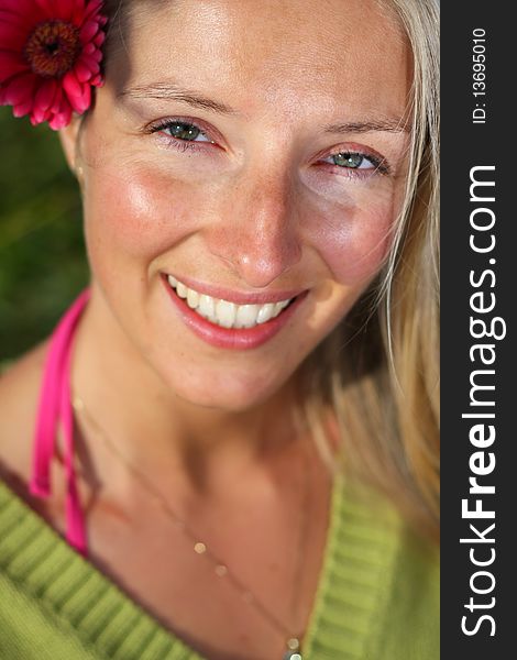 Natural caucasian blonde girl with red flower portrait. Natural caucasian blonde girl with red flower portrait