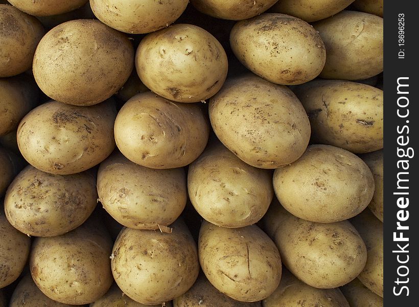 Earth treasures, raw potatoes background
