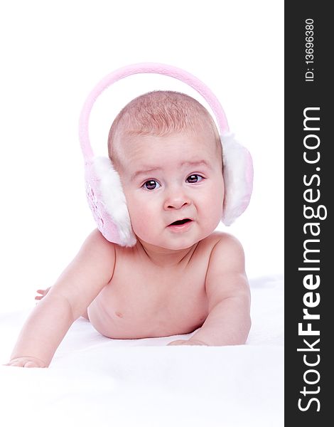 Happy baby with pink fur headphones on white background