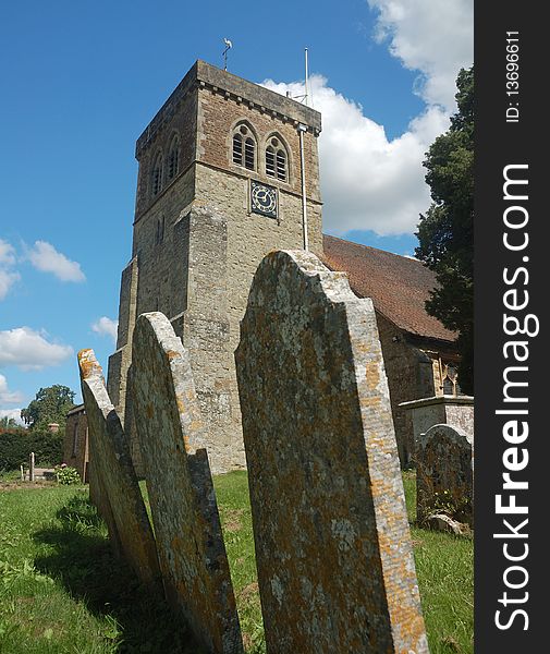 English parish church behind old gravestones. English parish church behind old gravestones