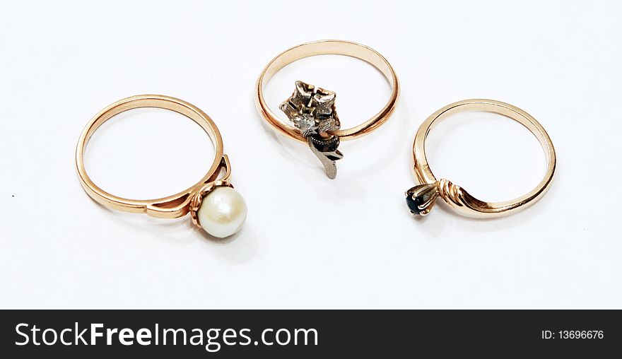 Three golden rings on a white