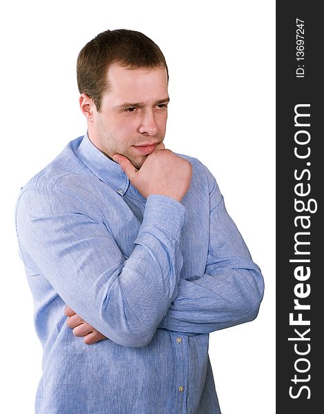 The man in a blue shirt thoughtfully rubs a chin, is isolated on a white background