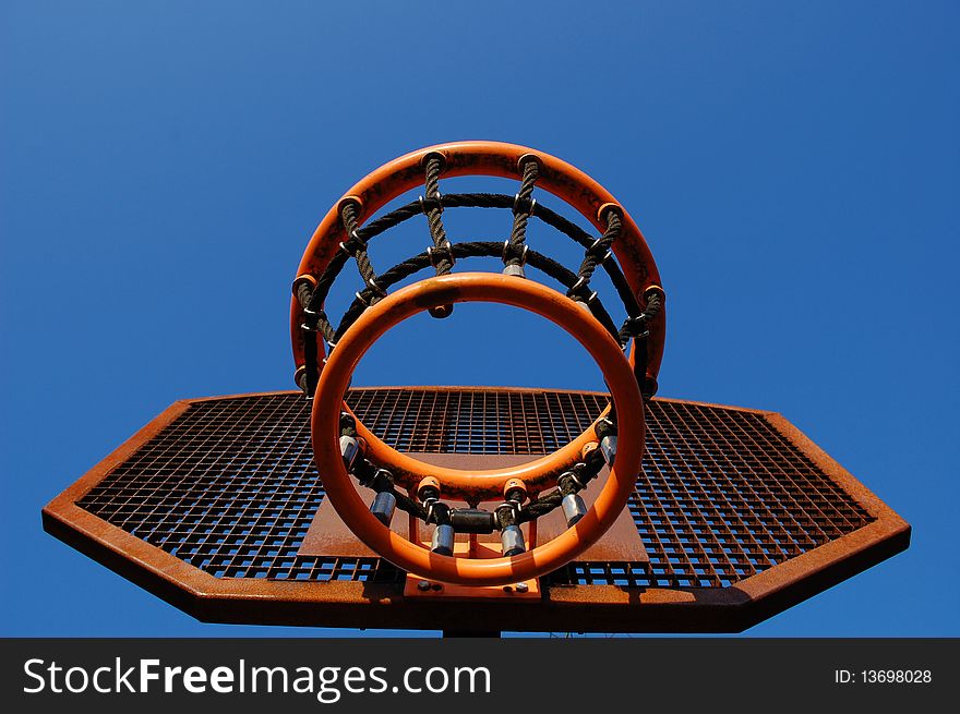 A basket on a sportsfield with a blue sky. A basket on a sportsfield with a blue sky