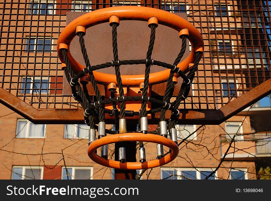 A basket on a sportsfield in the city. A basket on a sportsfield in the city