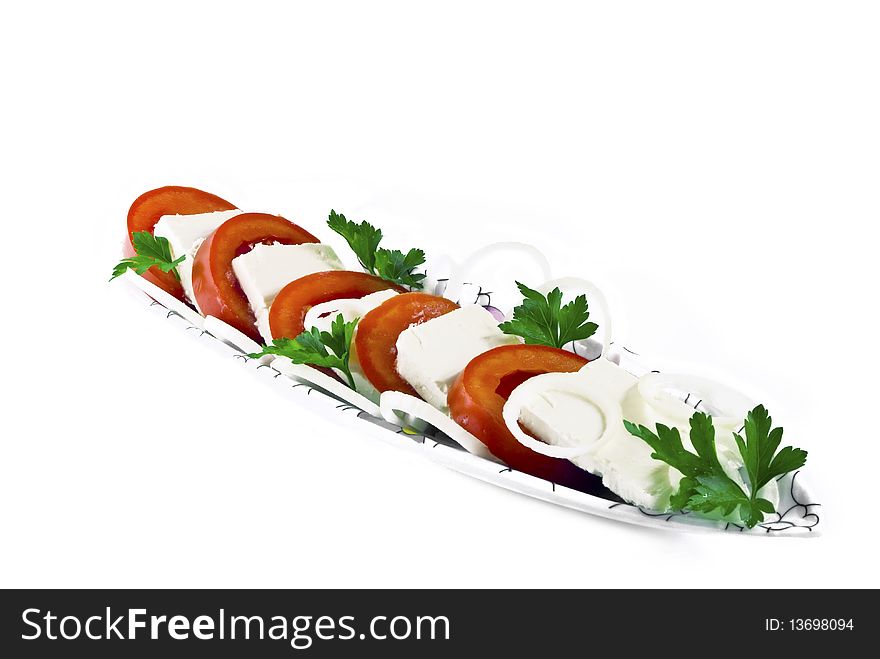 Sliced cheese and tomatoes, decorated with greenery, isolated. Sliced cheese and tomatoes, decorated with greenery, isolated