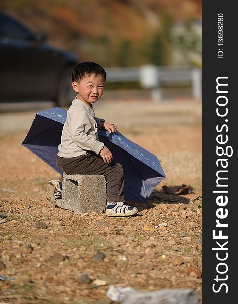 Asian boy sit with a Umbrella. Asian boy sit with a Umbrella