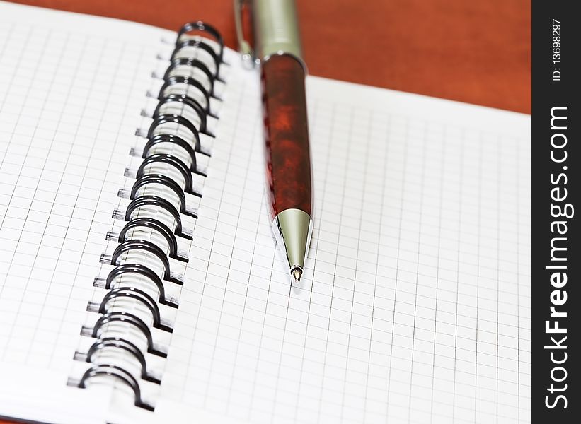 Pen with notebook on the desk. Pen with notebook on the desk