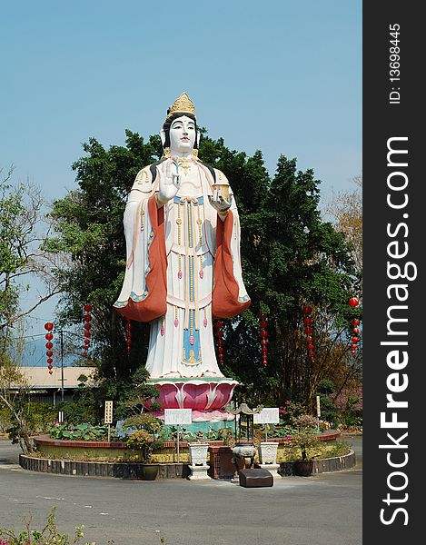 Guan yin statue with sky as background