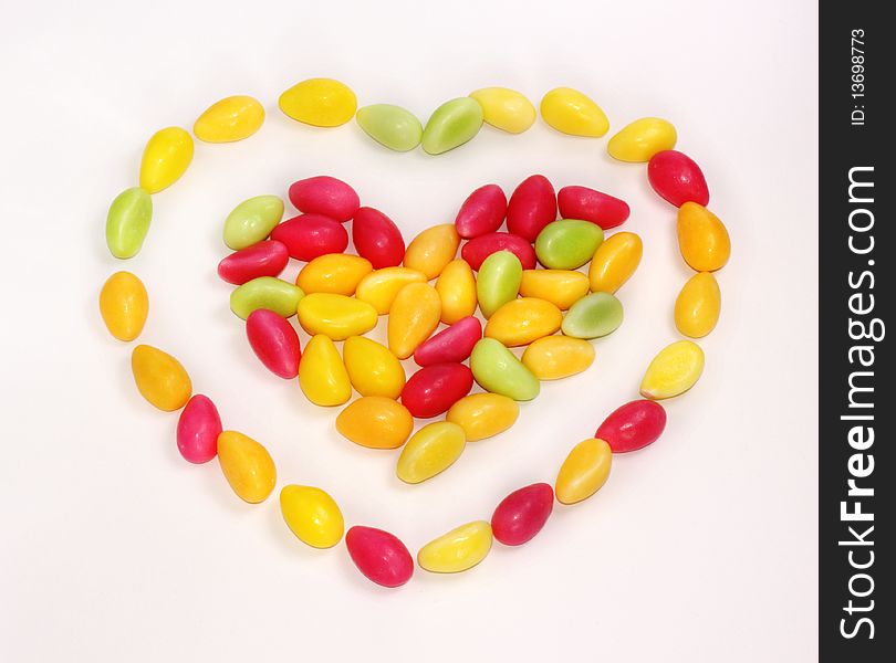 Heart shape made of candies on white background. Heart shape made of candies on white background