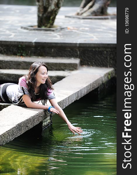 Chinese girl playing by water. Chinese girl playing by water.