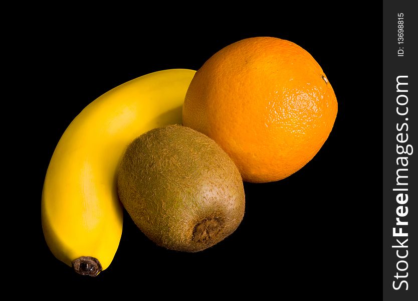 Still-life from a banana, an orange and kiwi on a black background. Still-life from a banana, an orange and kiwi on a black background