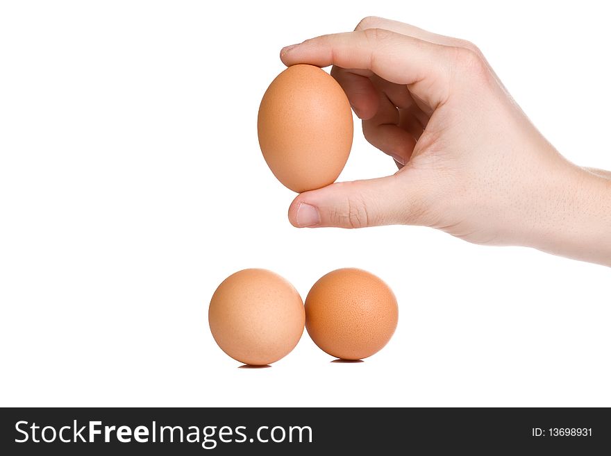 Isolated hand holding egg on white