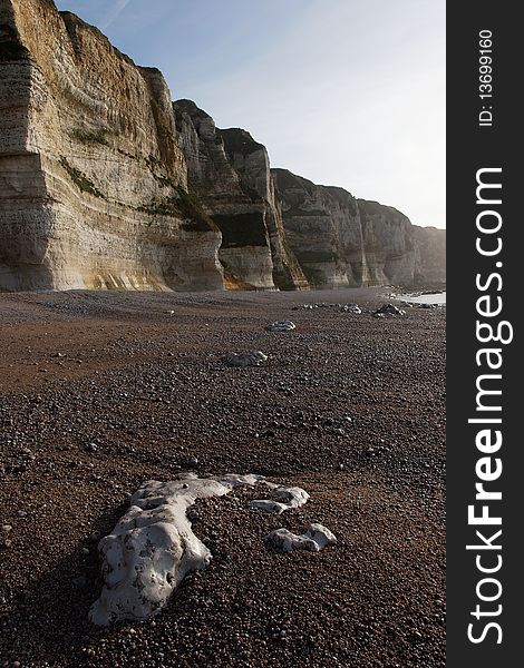 Normandy's beach whit high cliff and pebble on the floor. Normandy's beach whit high cliff and pebble on the floor