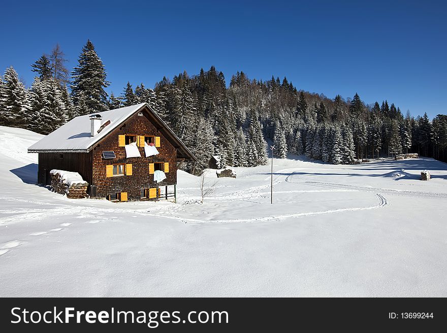 Rural sunny winter landscape with occupied chalet. Rural sunny winter landscape with occupied chalet