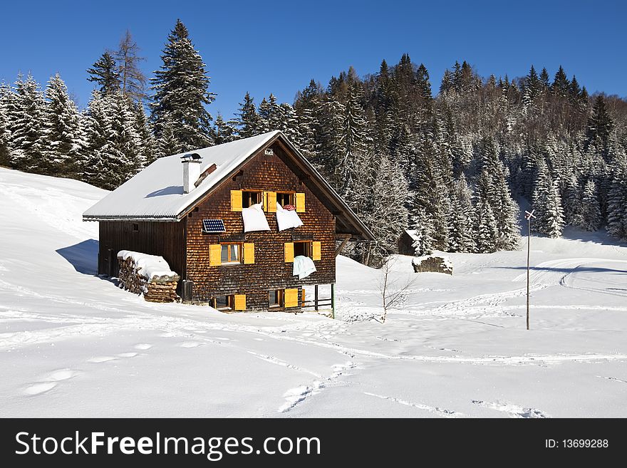 Rural sunny winter landscape with occupied chalet. Rural sunny winter landscape with occupied chalet