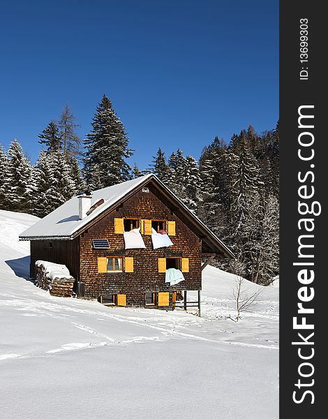 Rural sunny winter landscape with occupied chalet. Rural sunny winter landscape with occupied chalet