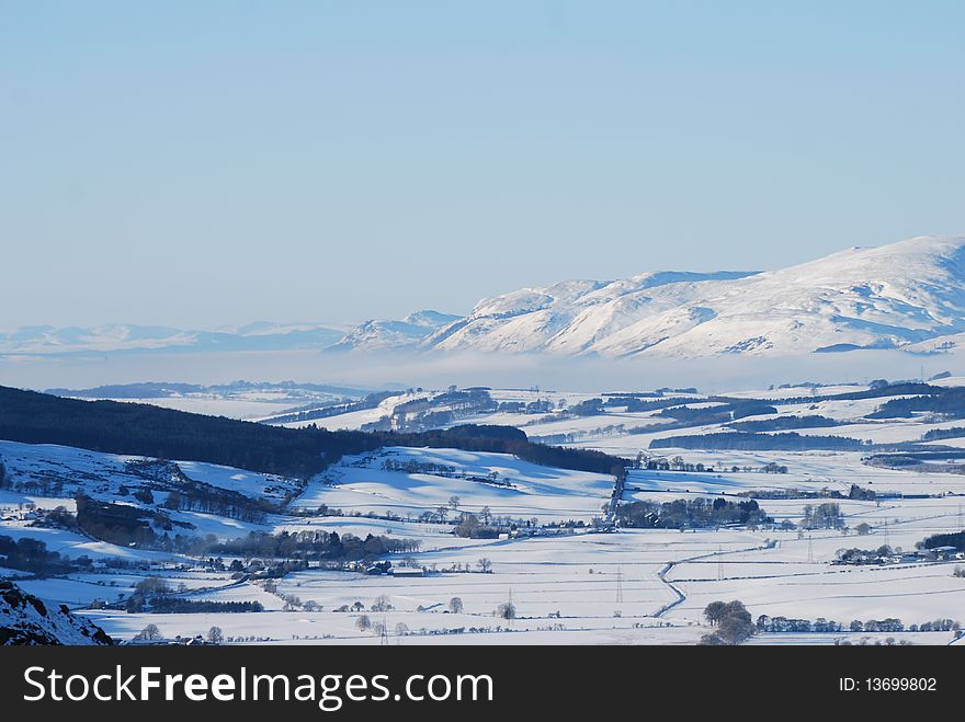 A view from the top of Benarty hill toward the Ochil hills where fog can be seen in the valley. A view from the top of Benarty hill toward the Ochil hills where fog can be seen in the valley