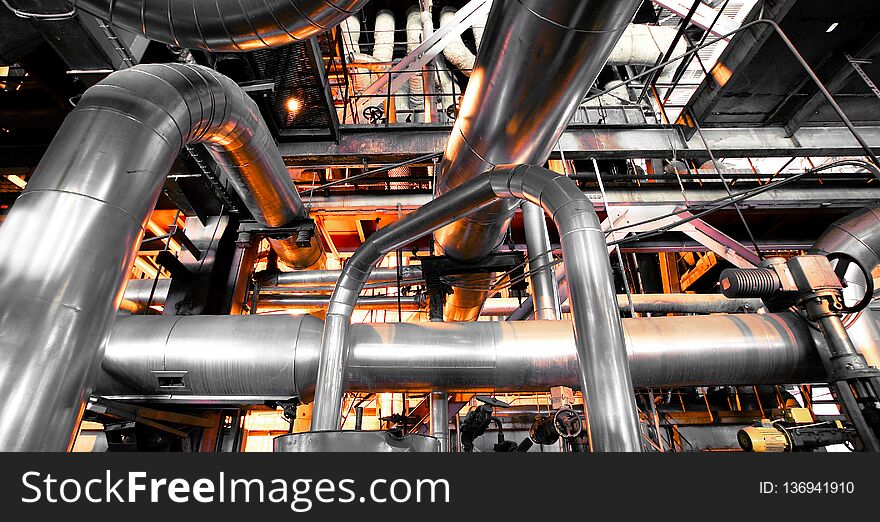 Equipment, cables and piping as found inside of a industrial power plant. Equipment, cables and piping as found inside of a industrial power plant