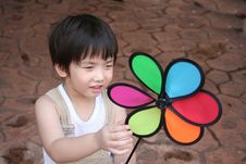 Boy & Colorful Windmill Royalty Free Stock Photography
