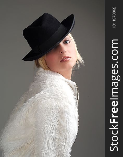 Beautiful young blond woman with hat close-up. Beautiful young blond woman with hat close-up.