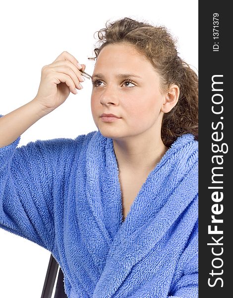 Isolated on white young woman dressed blue bathrobe using tweezer