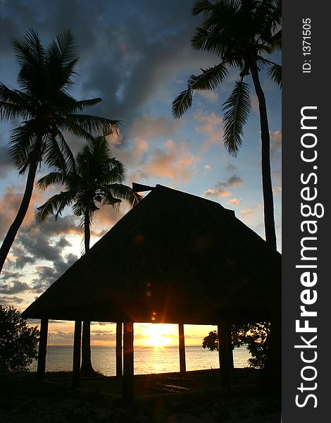 Sunset thru a hut in the pacific. Sunset thru a hut in the pacific