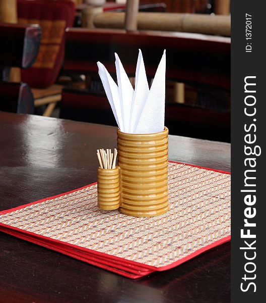 White tissues and toothpicks on a table in a restaurant. White tissues and toothpicks on a table in a restaurant