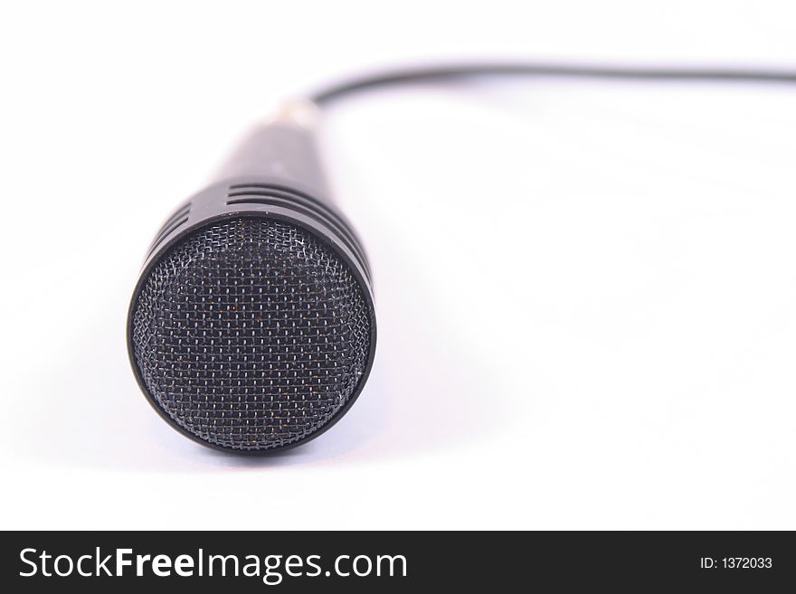 Off centre image of a microphone with the cord visible in the back ground. Off centre image of a microphone with the cord visible in the back ground.