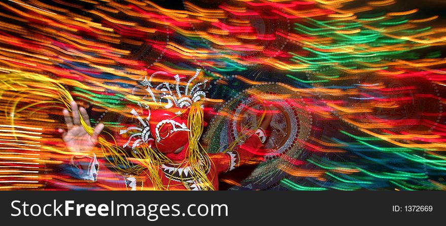 A Buddhist performs a traditional dance. A Buddhist performs a traditional dance.