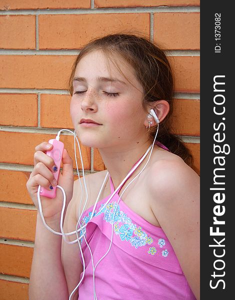 Beautiful girl listening  to music player lot of expression