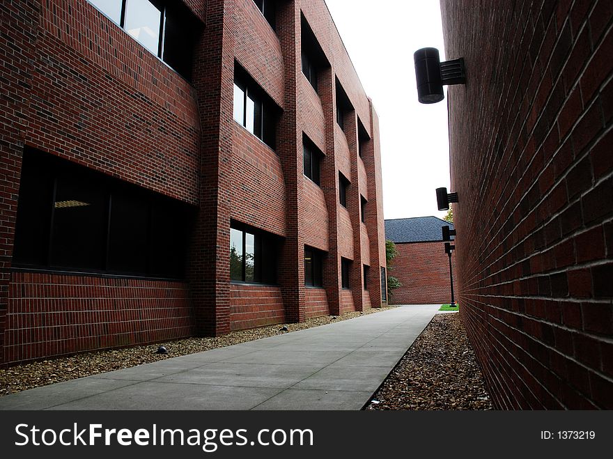 A walk way between two red brick building