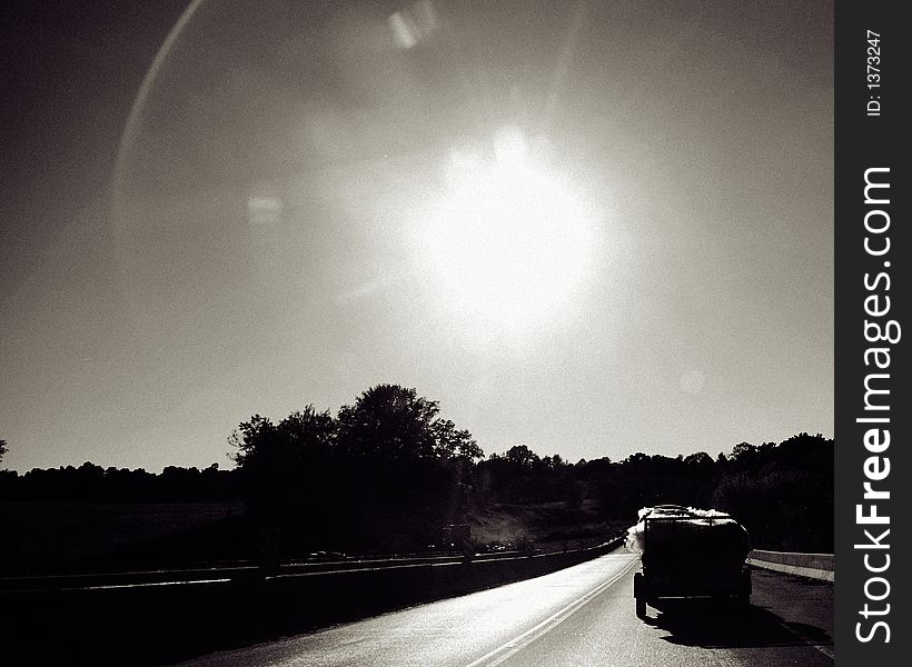 Driving in to the sunset in black and white