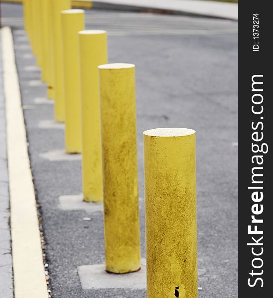 A line of yellow pole by the street