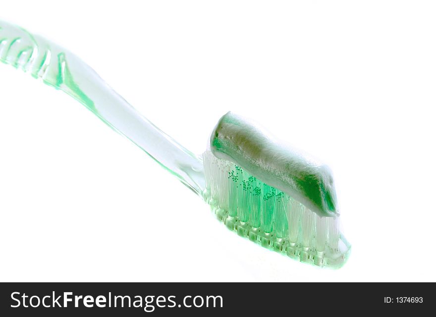 A green tooth brush with tooth paste