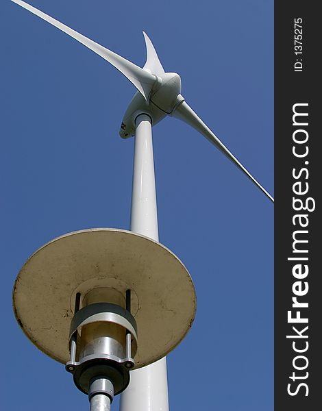 The propeller of a wind turbine photographed from the ground combined with the lamp of a lamp post. The propeller of a wind turbine photographed from the ground combined with the lamp of a lamp post.