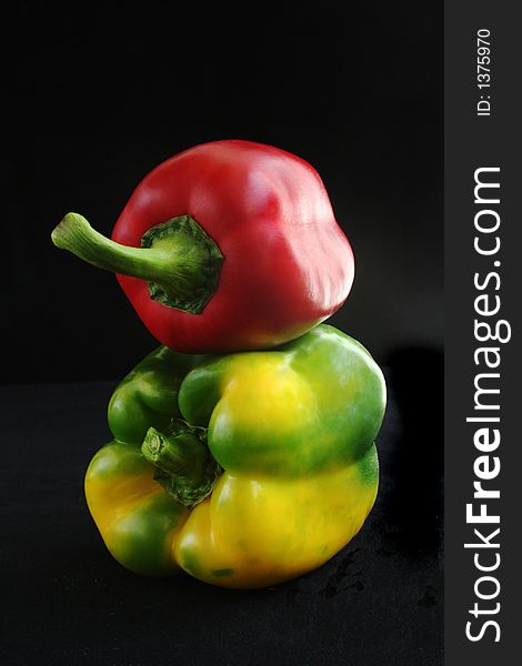 Red and Green Peppers over black back ground