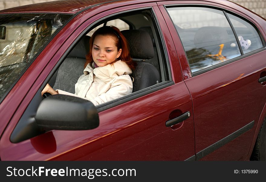 The young girl in the red automobile. The young girl in the red automobile