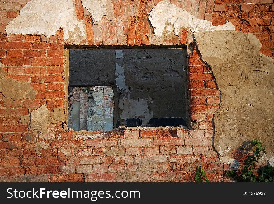 Window on old ruined building facing another wall. Window on old ruined building facing another wall