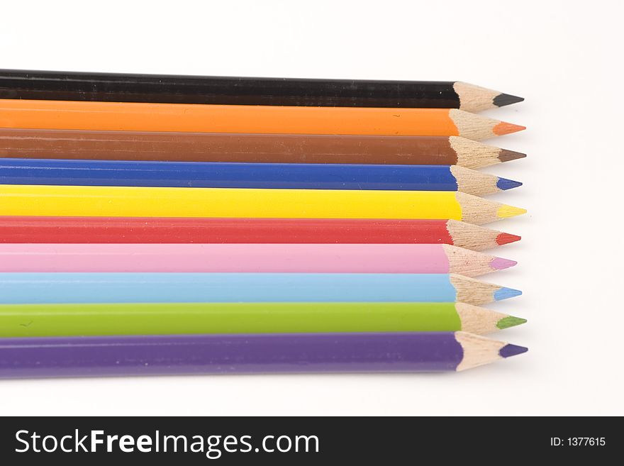 Multiple assorted coloured pencils against a white background. Multiple assorted coloured pencils against a white background.