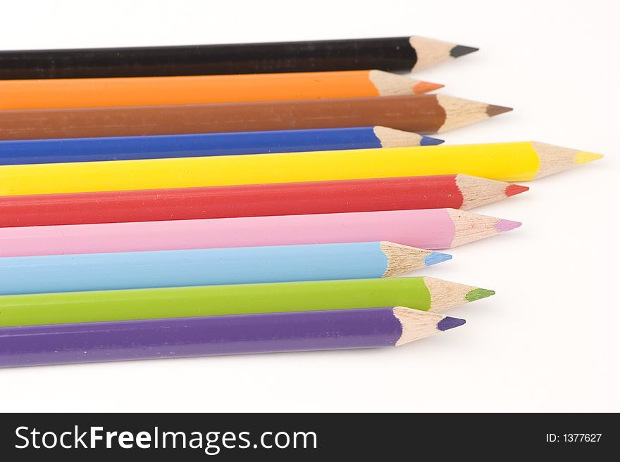 Multiple assorted coloured pencils against a white background. Multiple assorted coloured pencils against a white background.