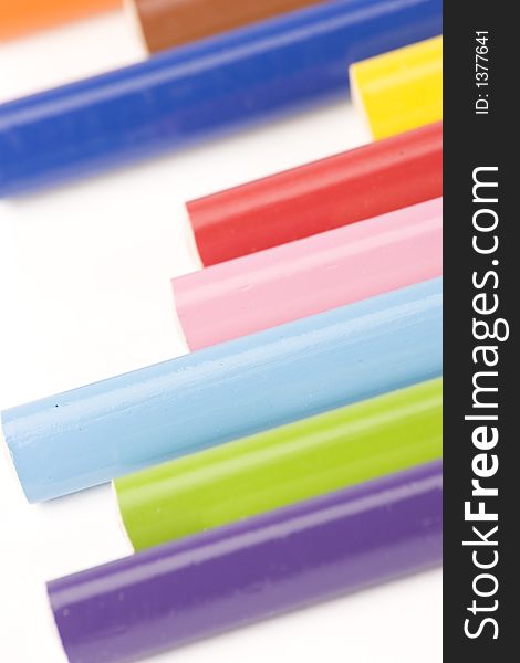 Multiple assorted coloured pencils against a white background. Multiple assorted coloured pencils against a white background.